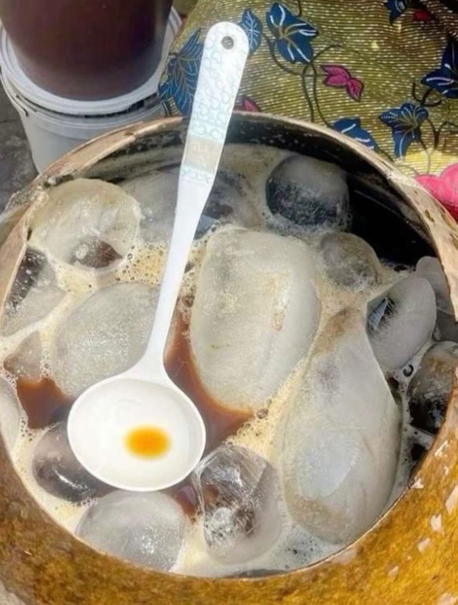 Chilled sobolo served in a calabash with a ladle