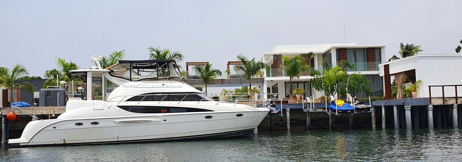 A yacht moored beside a waterfront resort