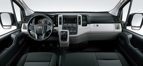 The driver's dashboard and steering wheel of a JATA Tours minibus