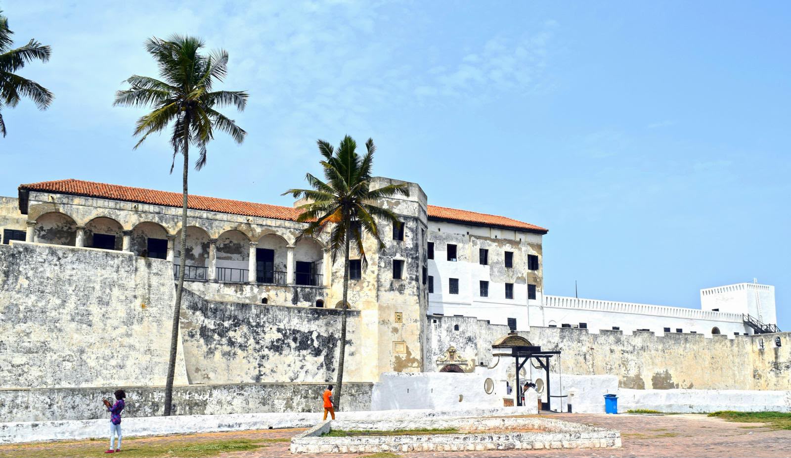 Arched loggias and palm trees along the walls of Elmina Castle
