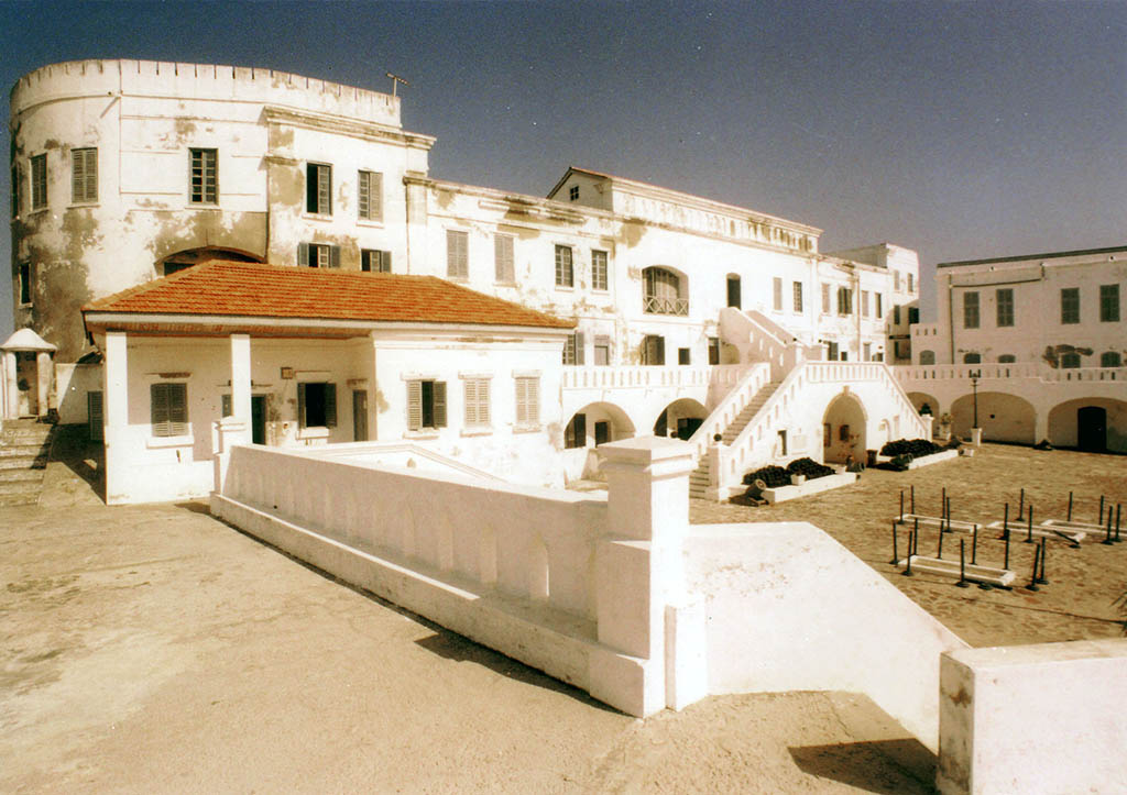 The white walls of Cape Coast Castle above the Atlantic shoreline