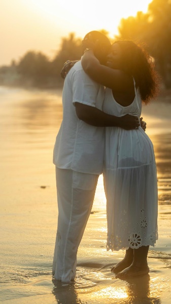 A couple embracing on the beach at sunset