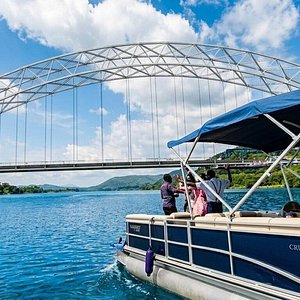 A cruise boat passing beneath the Adomi Bridge on Lake Volta