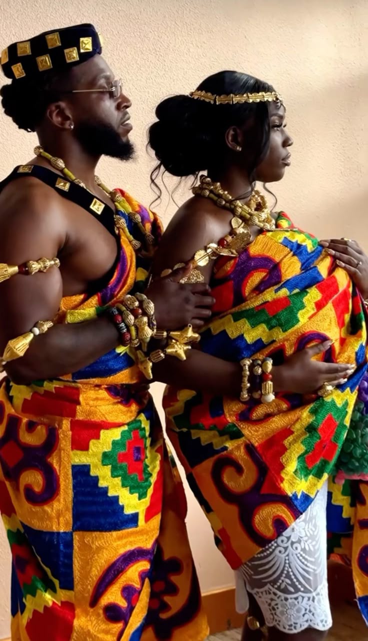 A couple in traditional Ghanaian Kente cloth and gold regalia