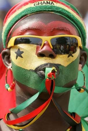 Ghana football fan with painted flag face