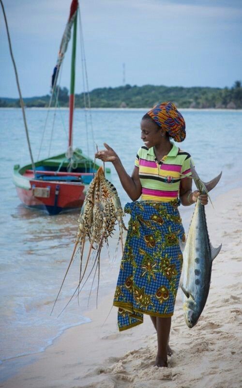 Fisherwoman on the coast with fresh catch