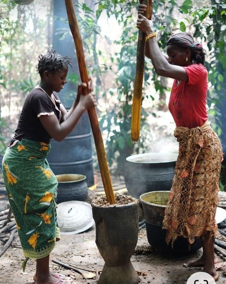Women pounding fufu in a traditional kitchen